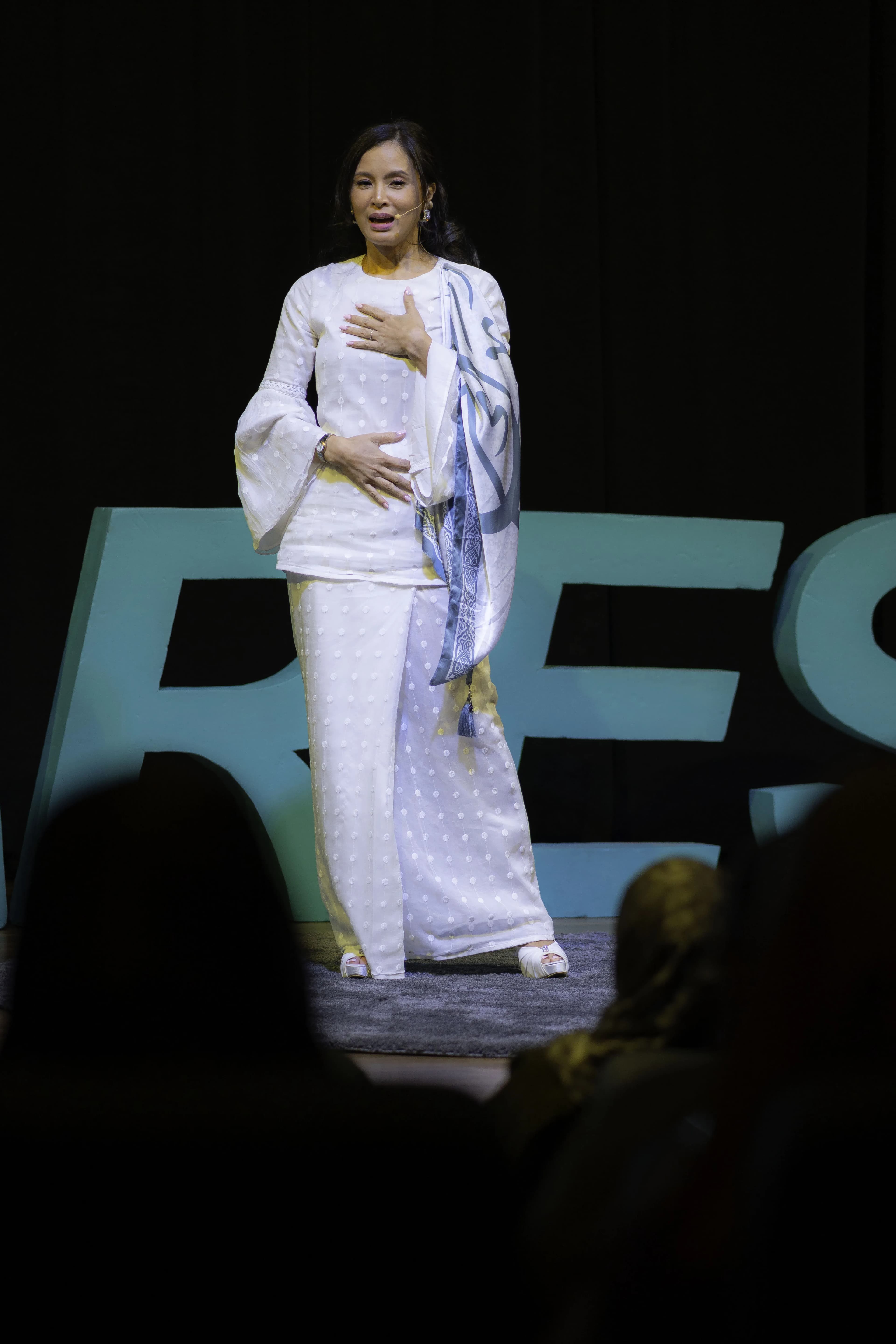 Daphne Iking speaking on stage at Deft Talks